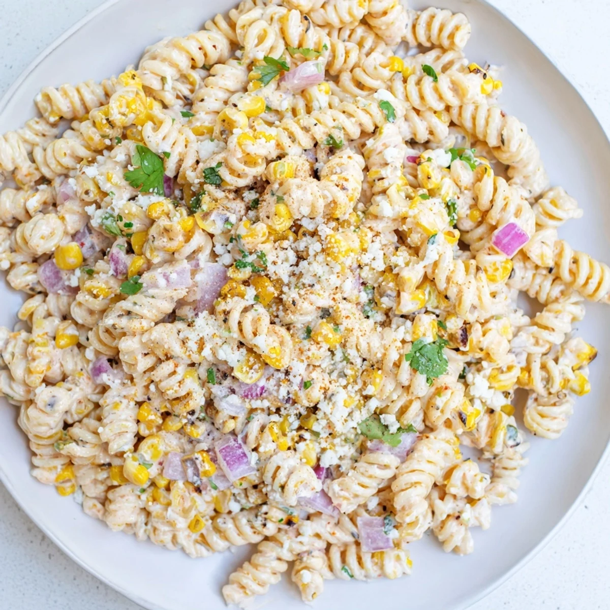 This Creamy Street Corn Pasta Salad showcases a vibrant mix of pasta and fresh, colorful ingredients.