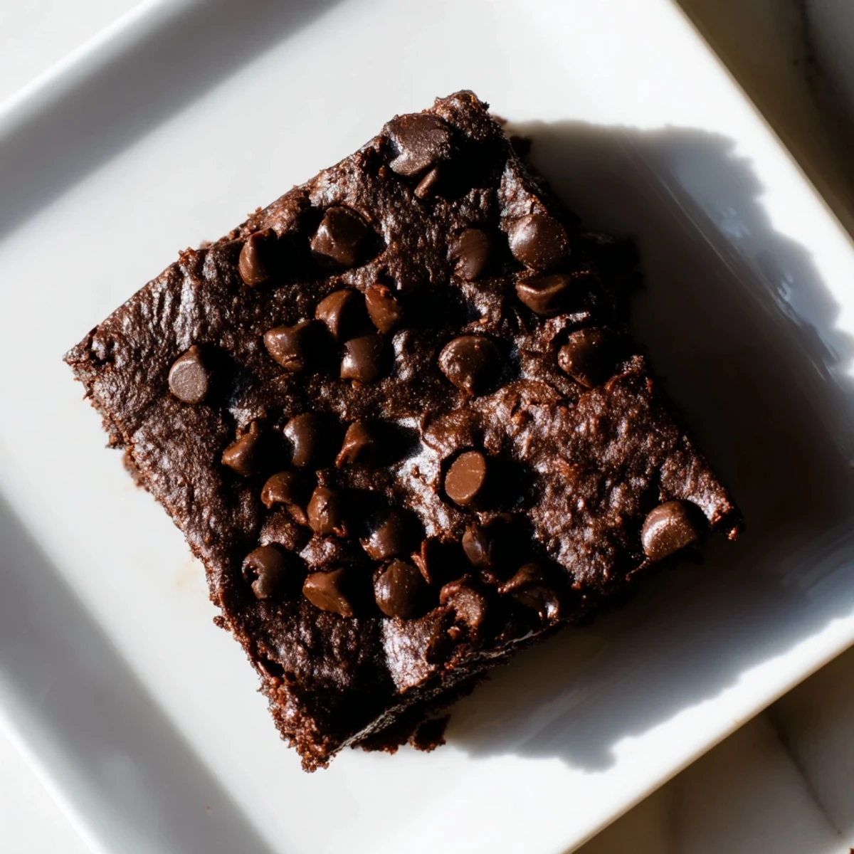 Fudgy Greek yogurt brownies, topped with melted chocolate, offer a rich, dark treat.