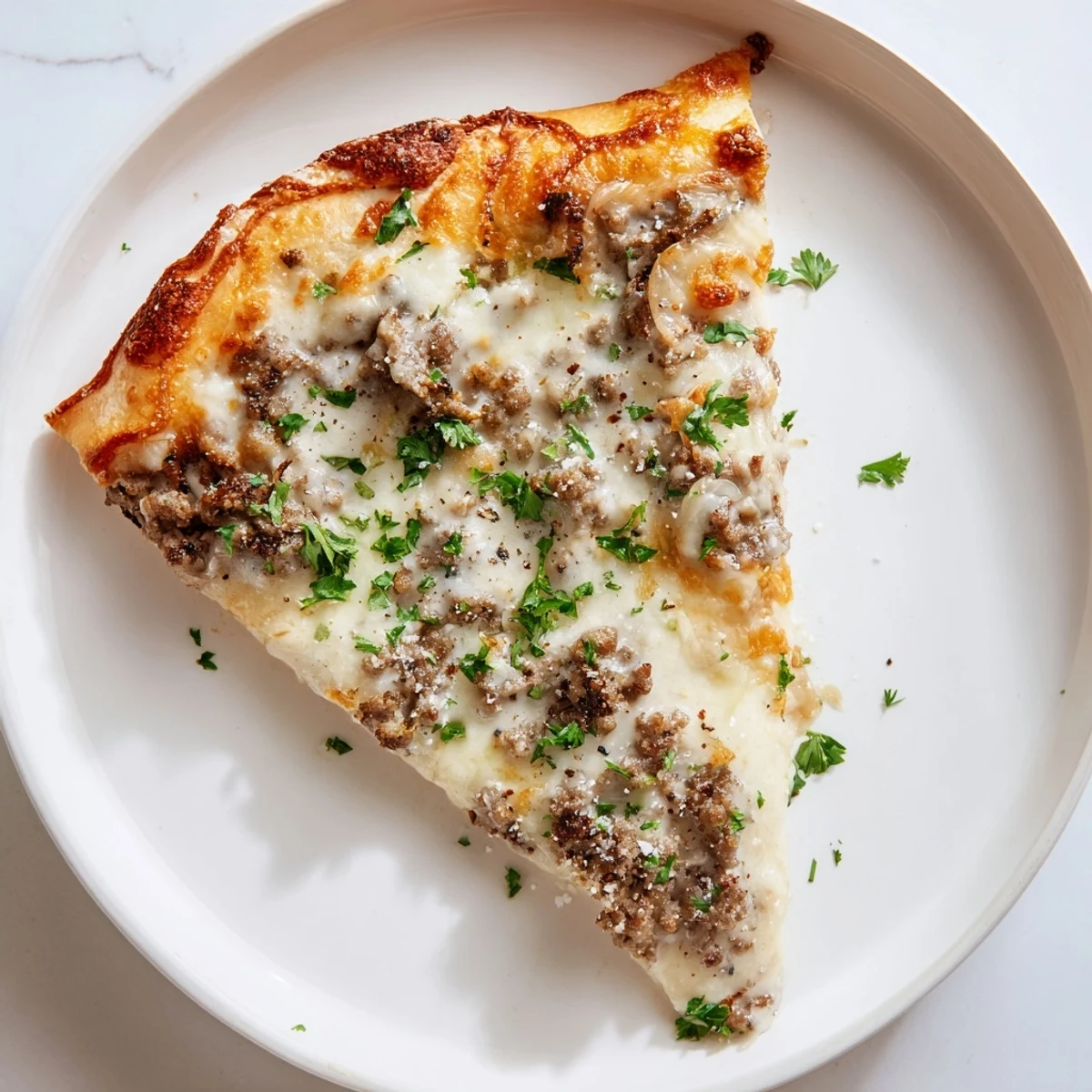 Melted mozzarella generously tops the flavorful Ground Beef Alfredo Pizza, ready to slice and enjoy.