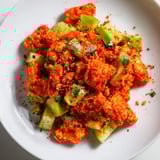 Flamin Hot Cheeto Salad served in a bowl, featuring crushed Cheetos tossed with crisp vegetables.