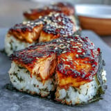 Japanese grilled salmon onigiri showcasing golden, crisped rice with savory salmon nestled inside.  