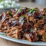Tender, shredded Juneteenth BBQ Pulled Pork piled high with refreshing watermelon slaw.