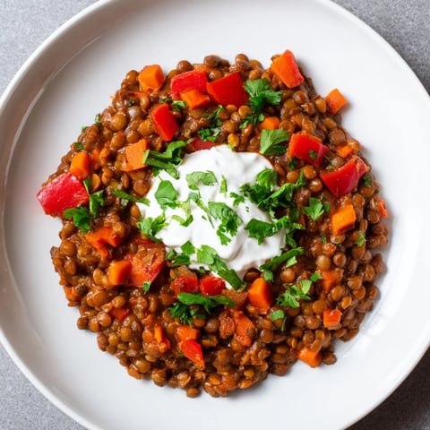 Golden, steaming Wheat-Warm Hearty Lentil Curry with vibrantly diced vegetables and a fragrant aroma.