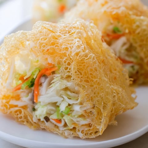 Golden brown Crispy Rice Paper Dumplings, sizzling in the pan, perfect for a flavorful vegan appetizer.