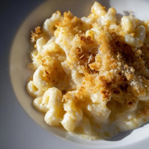 Golden-brown baked mac and cheese bubbling in a dish, ready for serving everyone a comforting meal.