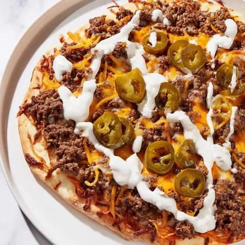 Ground Beef Taco Pizza: A delicious close-up showcases a bubbly, cheesy pizza ready to eat.