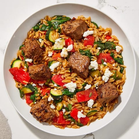 Tender lamb and orzo simmer in flavors of the Smoky Mediterranean Lamb and Orzo Supper, ready for serving.
