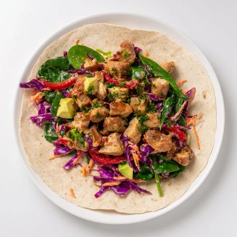 Freshly assembled Poppy-Inspired Chicken Salad Wraps, filled with colorful ingredients, perfect for lunch.