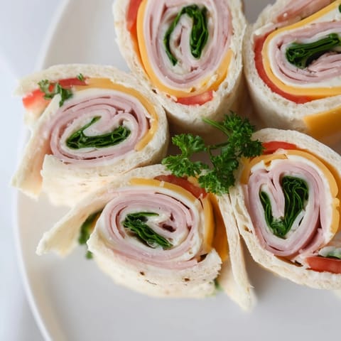 Vibrant photo of easy-to-make star-shaped deli roll-ups, perfect party sandwiches for any gathering.
