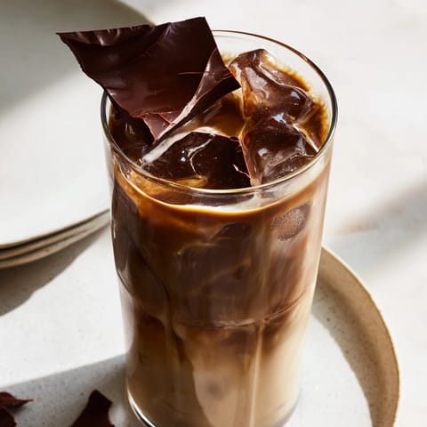 Indulge in a homemade Chocolate Cracking Iced Latte, showcasing a beautifully cracked chocolate layer.