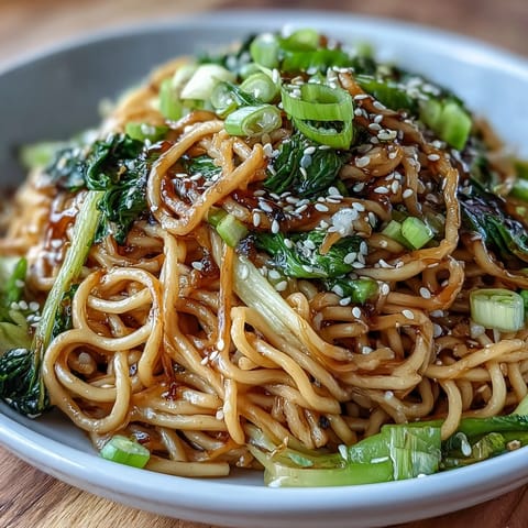 Silky wheat noodles tossed in savory ginger-scallion sauce, served with tender baby bok choy and snap peas.