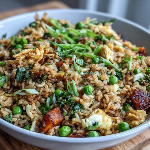 Healthy vegetarian fried rice loaded with colorful vegetables and aromatic ginger-garlic, served hot from the wok.  
