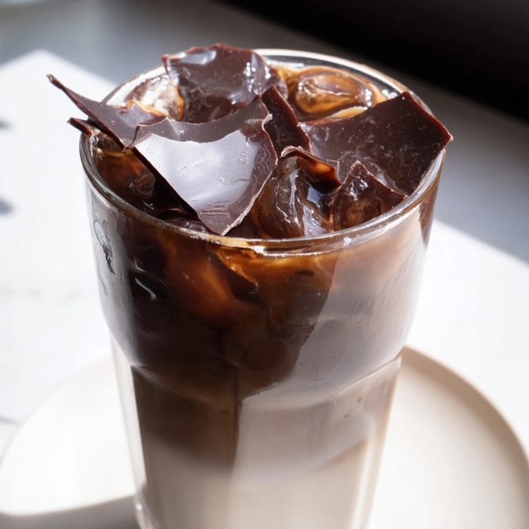 Enjoy a refreshing Chocolate Cracking Iced Latte; espresso, milk, ice, and rich chocolate blend.