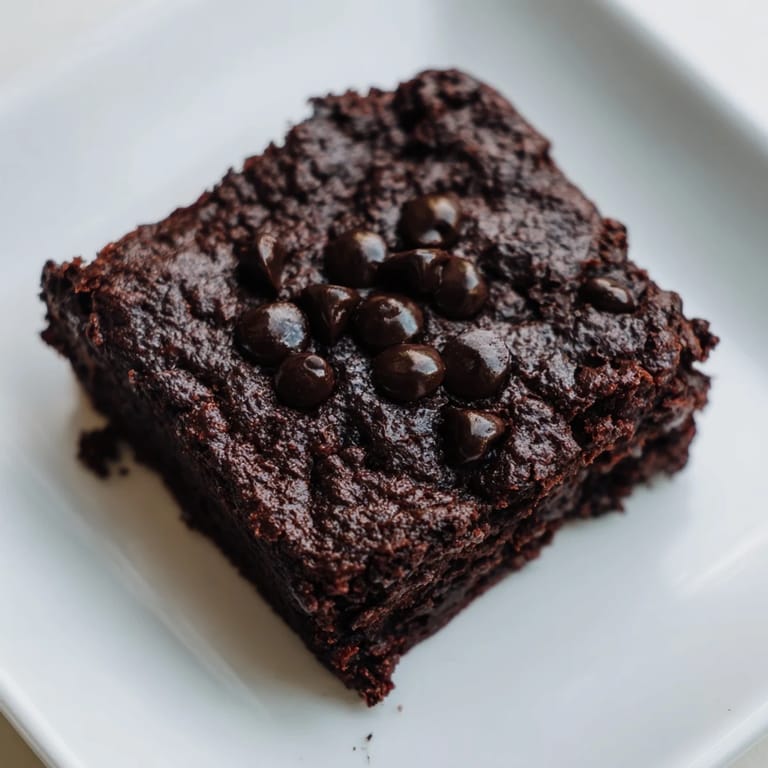 Warm, freshly baked Greek yogurt brownies, with a delightful aroma and perfect for dessert.