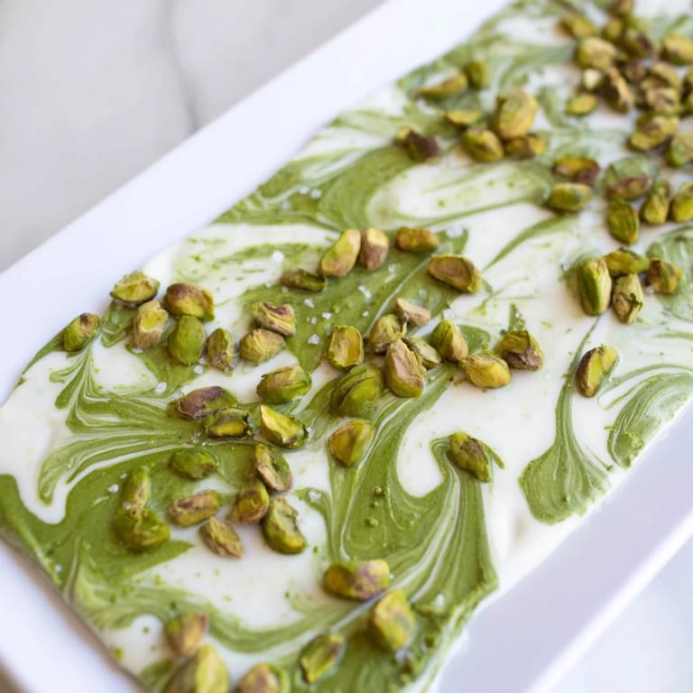 A close-up of a delicious Pistachio Matcha White Chocolate bark, showing the vibrant green matcha powder.
